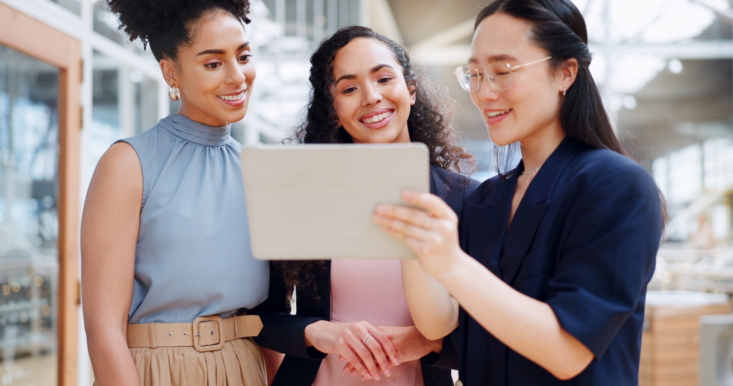 Businesswomen viewing hotel asset management tools on a table